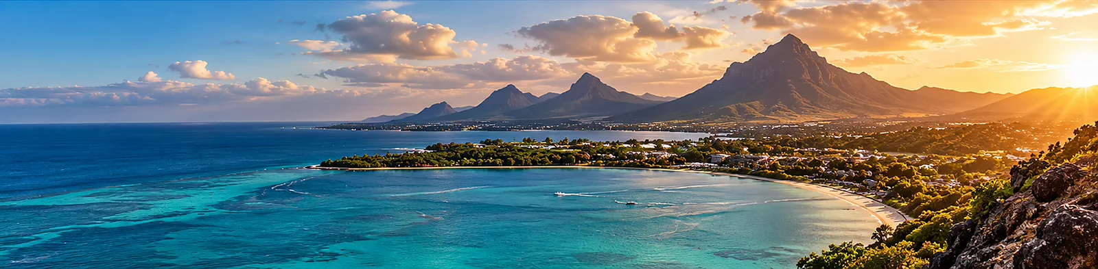 A bay on the coast of Mauritius and its mountains at golden hour